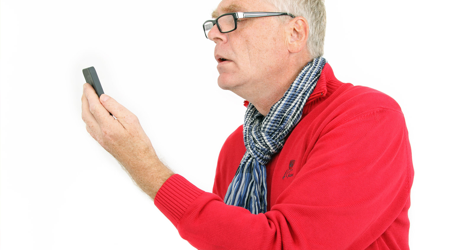 Ein älterer Herr schaut verzweifelt über seine Brille auf ein Smartphone oder ähnliches Gerät und versucht etwas zu entziffern