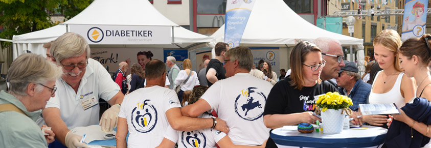 Infozelt der Diabetiker Niedersachsen, im Vordergrund Aktive im Gespräch mit Menschen